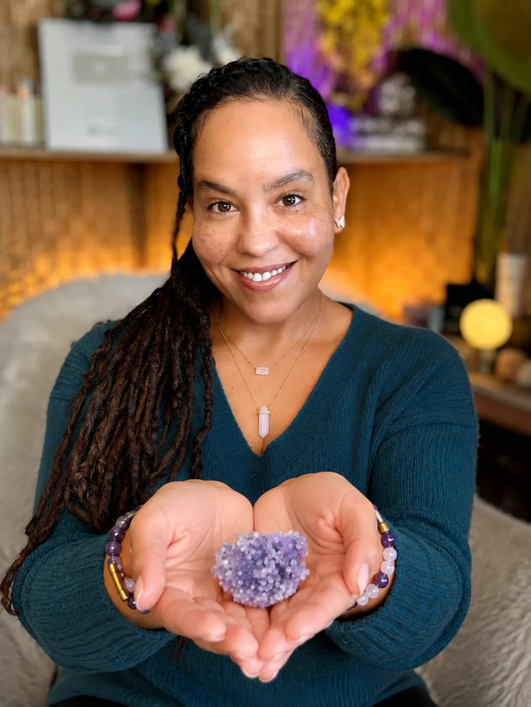 Dahlia holding a Grape Agate cluster in her open palms